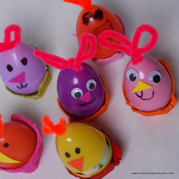Plastic Easter egg crafts made from purple, orange, yellow, and pink plastic eggs which all have crazy hair made from pink and orange pipe cleaners, and they have faces drawn on or googly eyes.