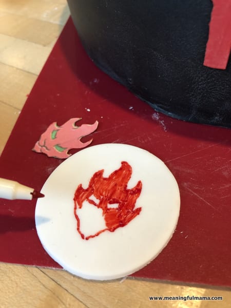 Using Edible Markers to Draw Ninjago Symbols on Cake