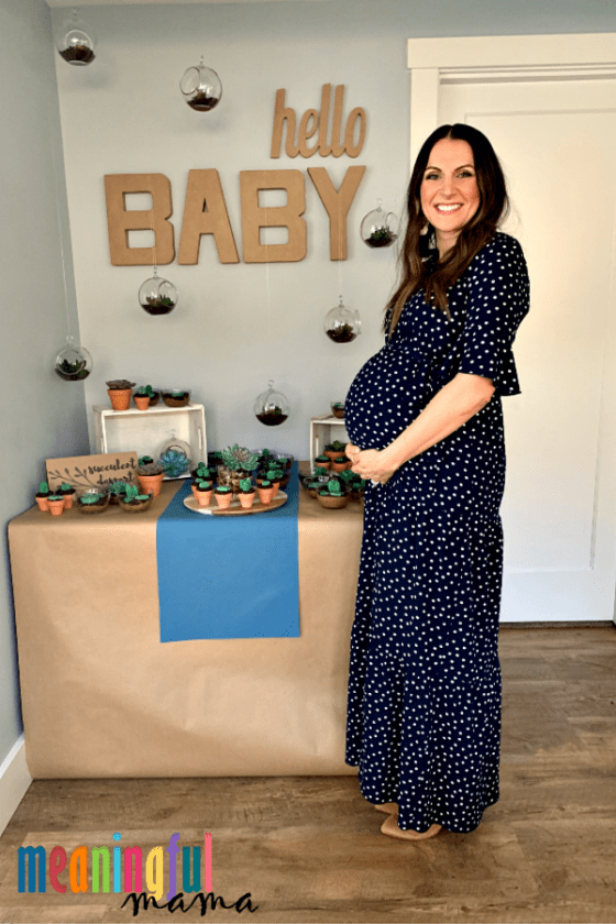 pregnant lady in front of baby shower succulent dessert table